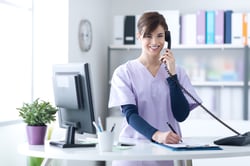 bigstock-Smiling-Receptionist-At-The-Cl-136924850-1