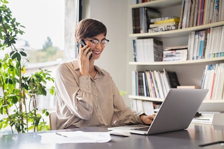 bigstock-Young-business-woman-using-lap-361603828